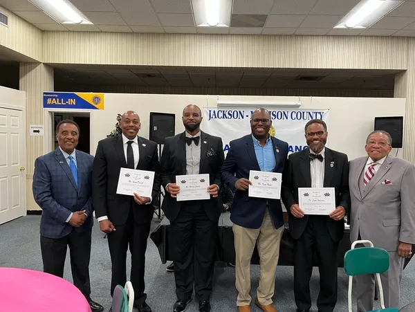 Smiling men at recognition ceremony