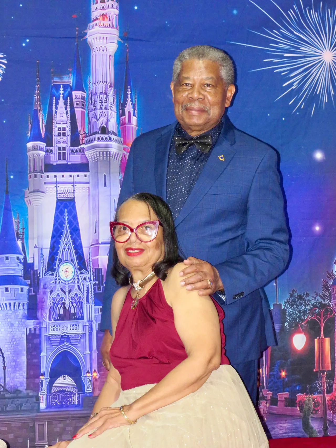 Couple posing in front of castle backdrop