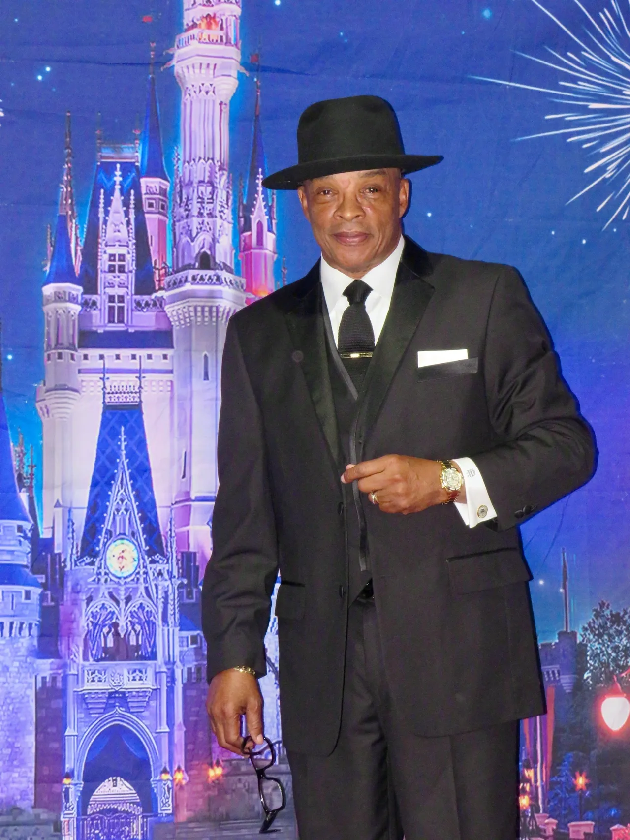 Elegant man standing in front of castle