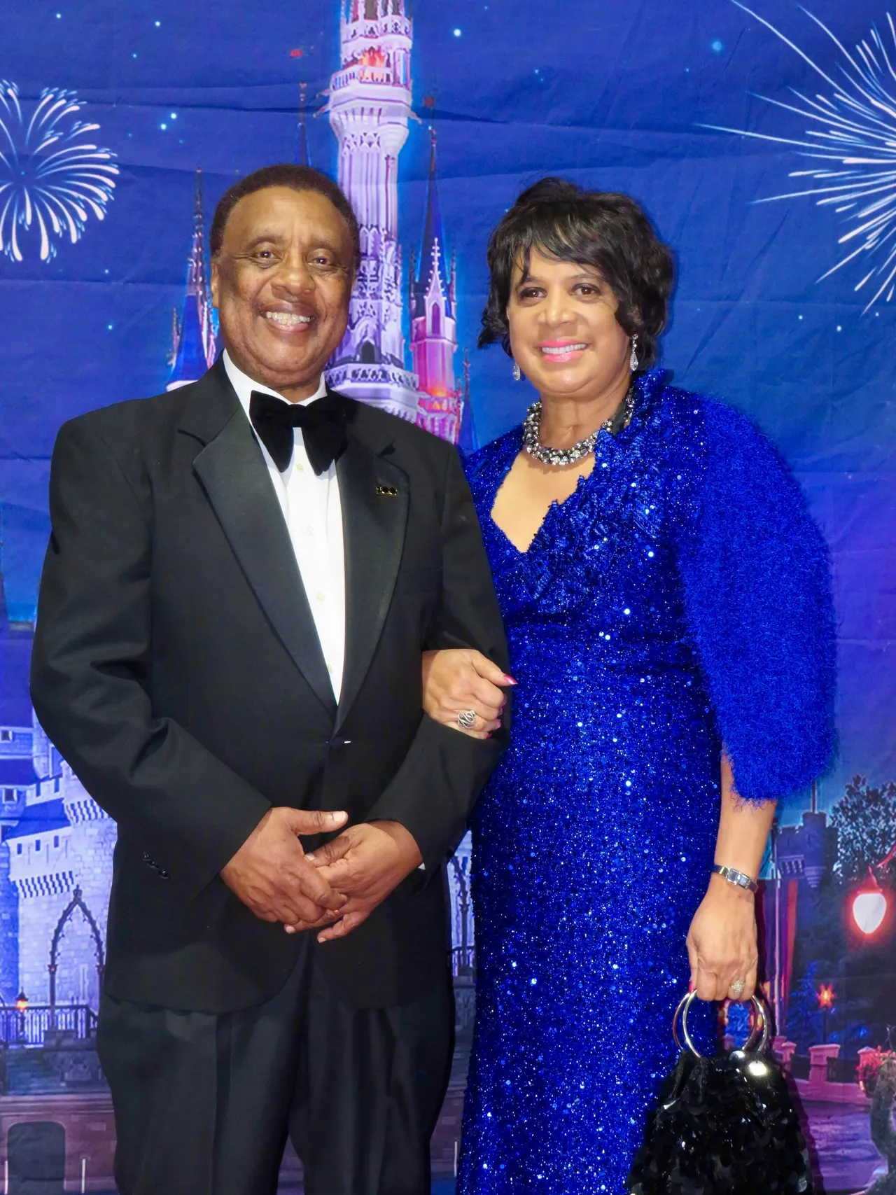 Couple posing with fireworks background