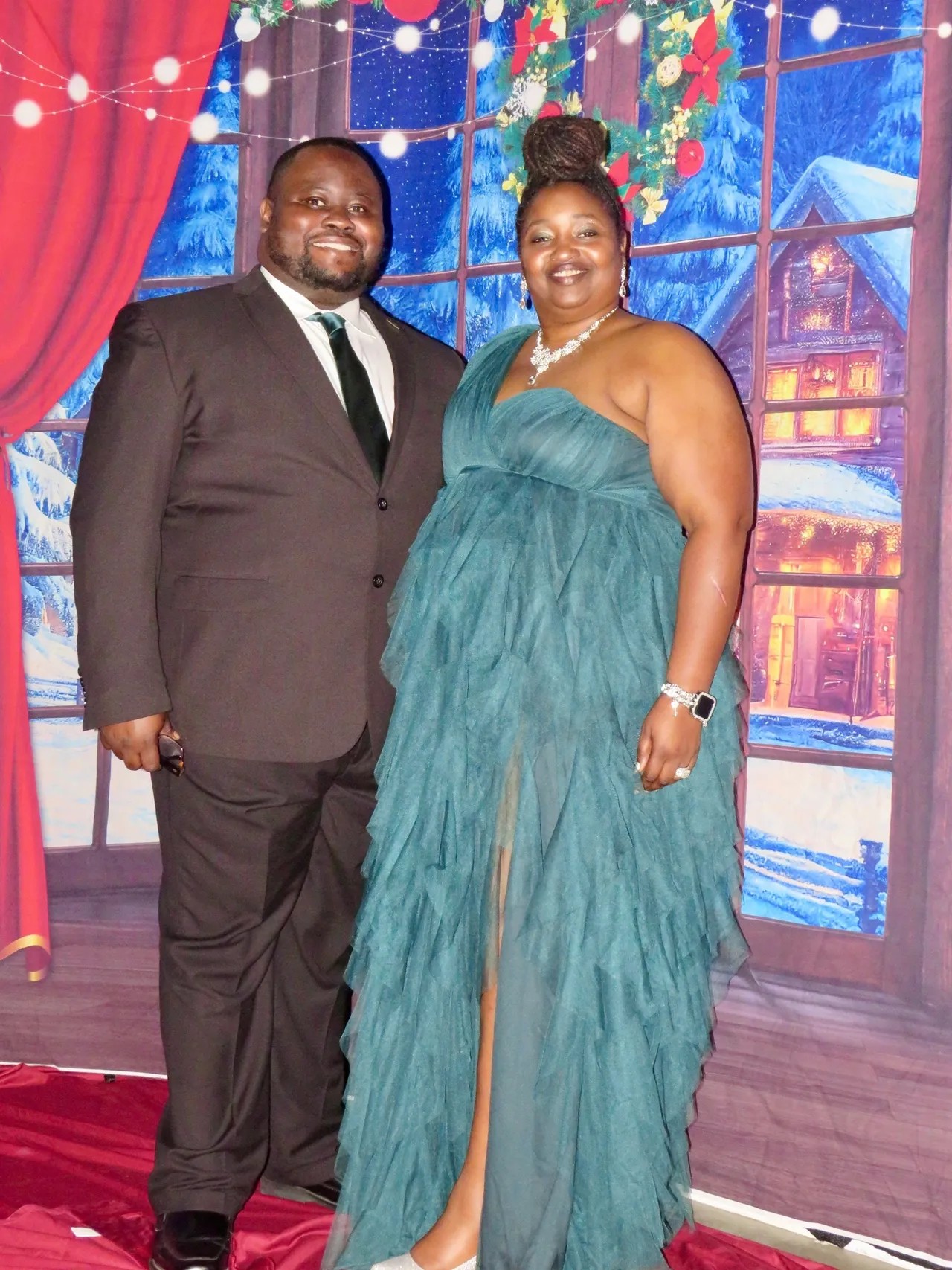 Elegant duo posing by festive window