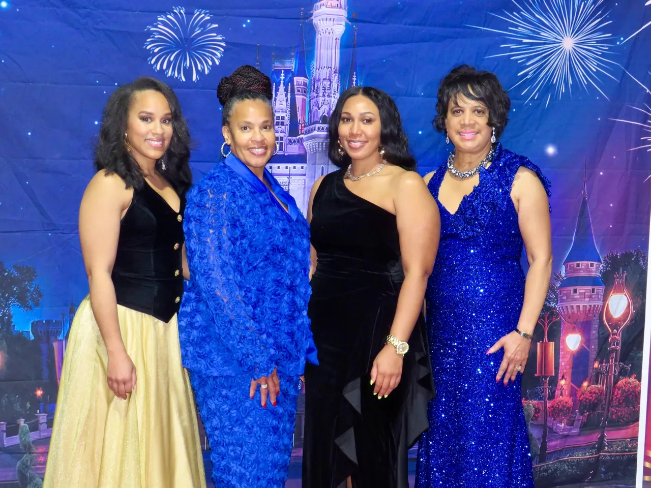 Women posing in front of castle backdrop