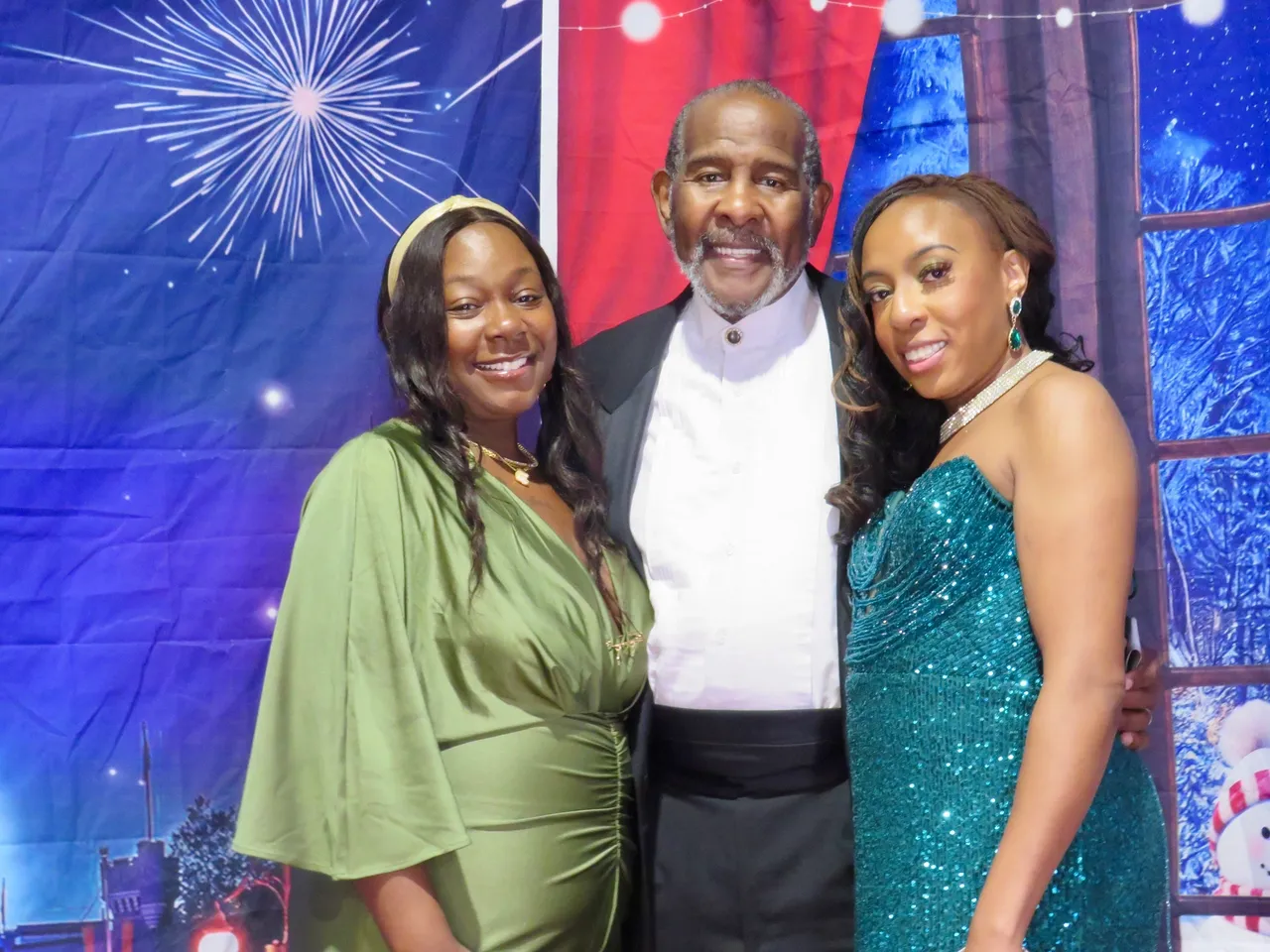 Three people smiling in formal attire