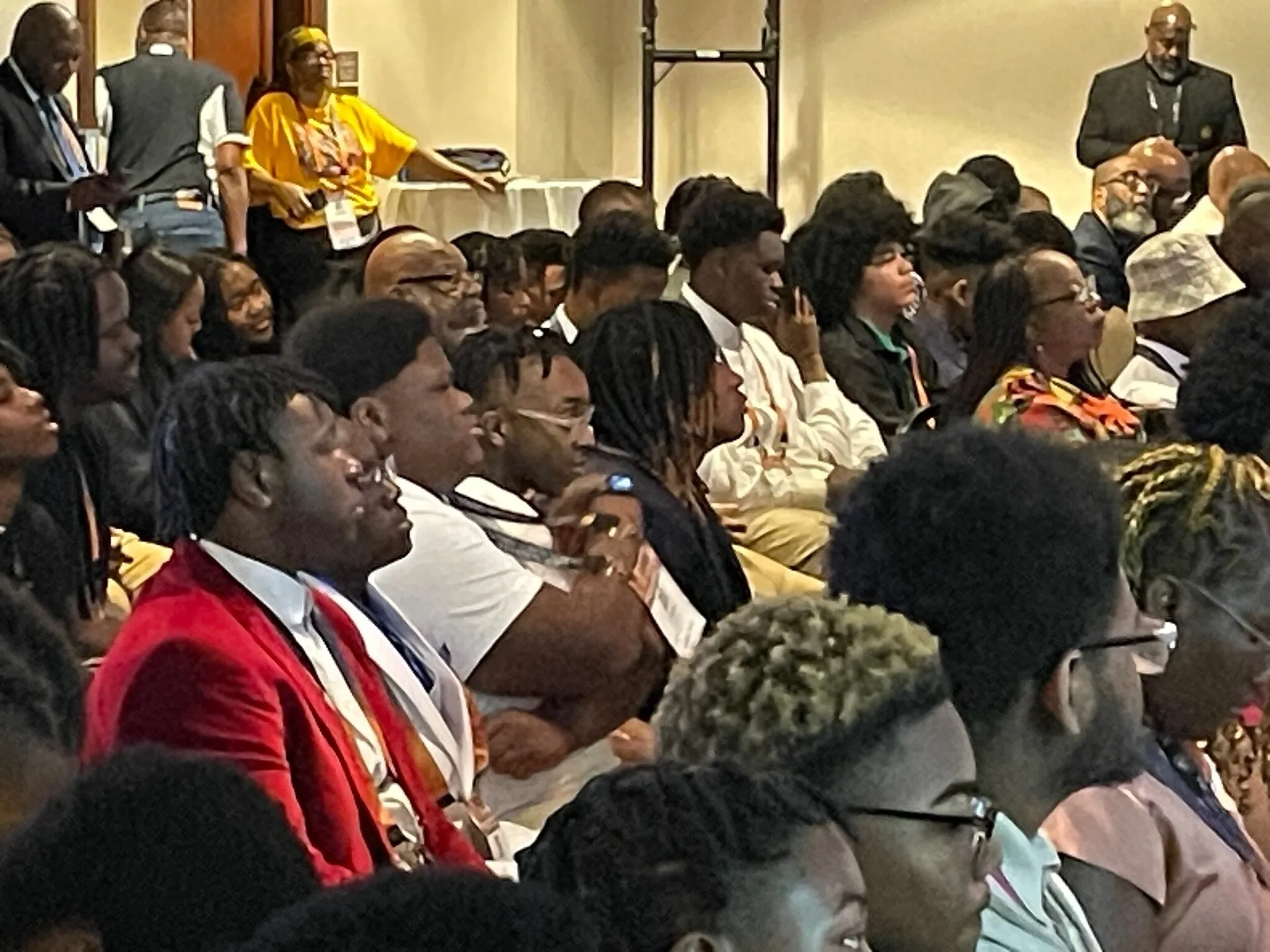 People seated in rows at meeting