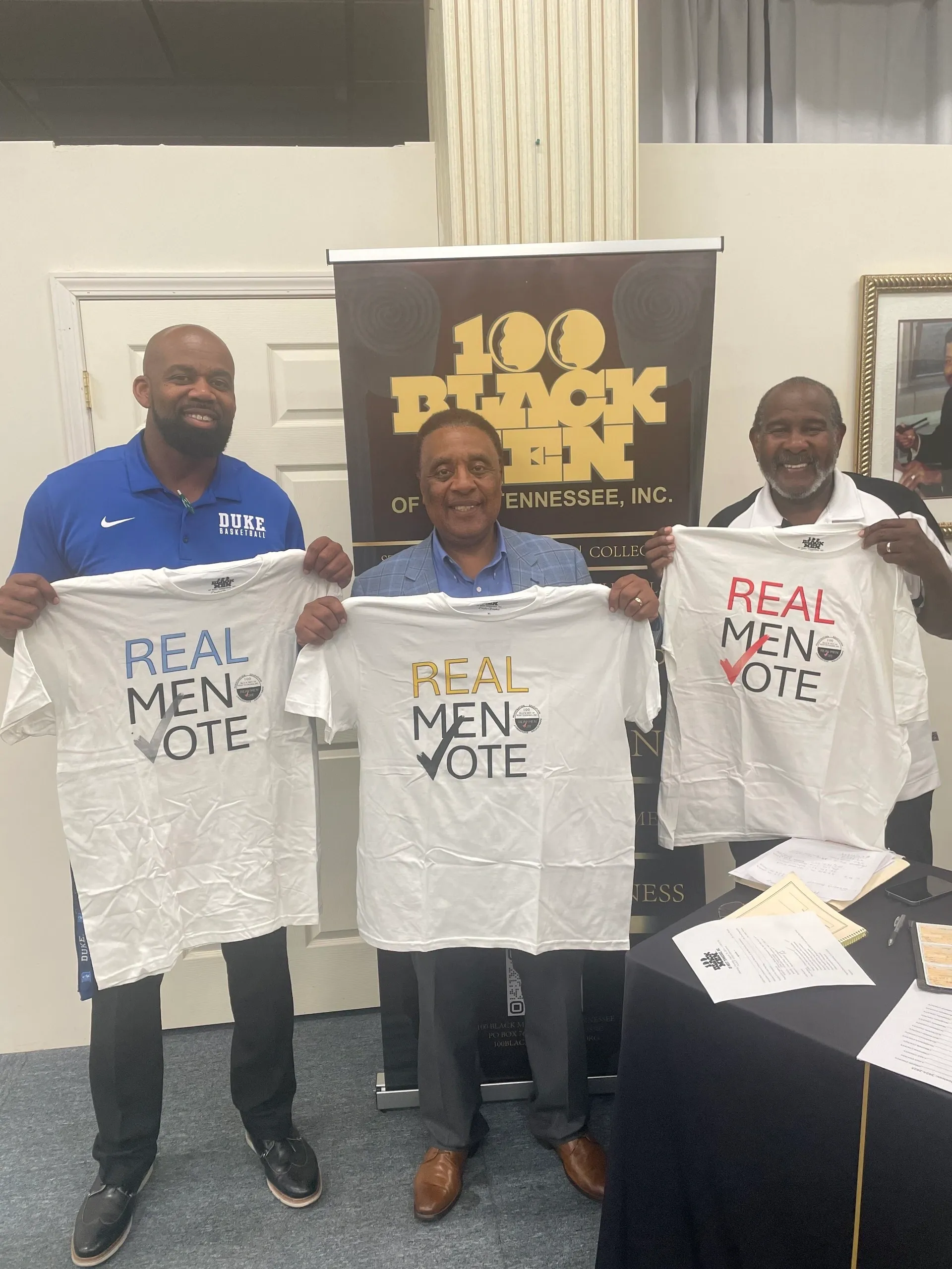 Group showcasing "Real Men Vote" message