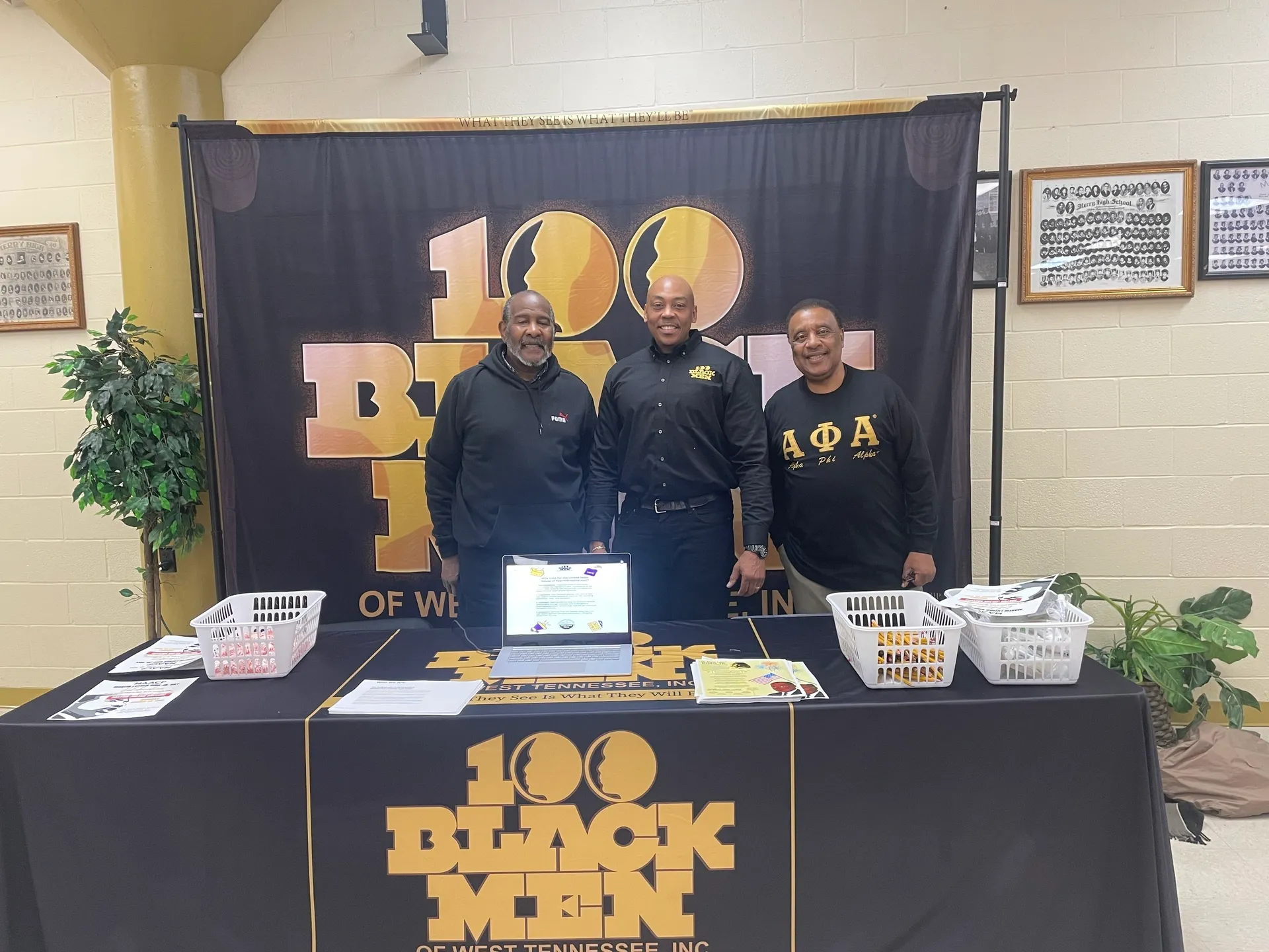 Three men at informational booth