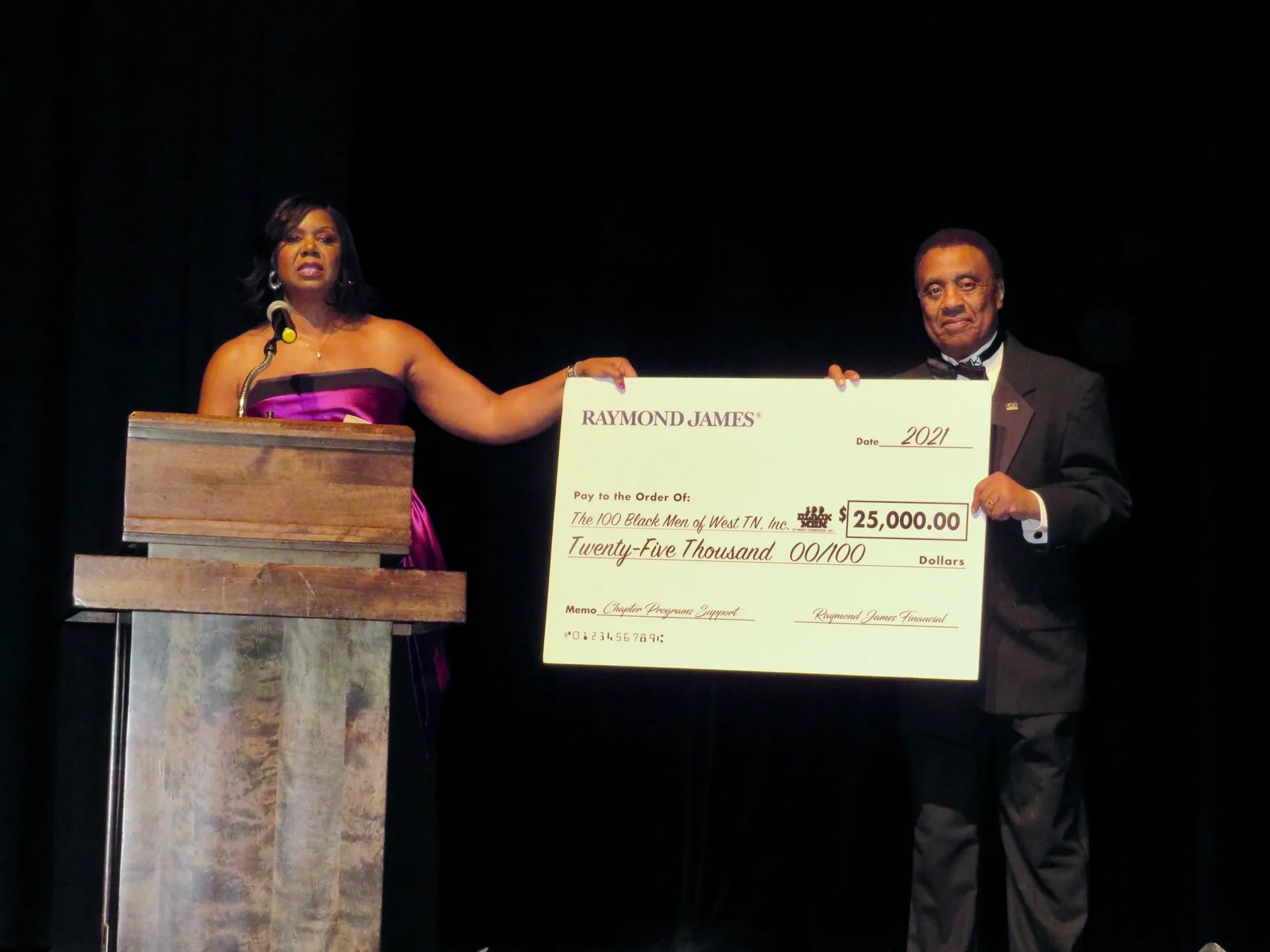 Formal event with oversized check display