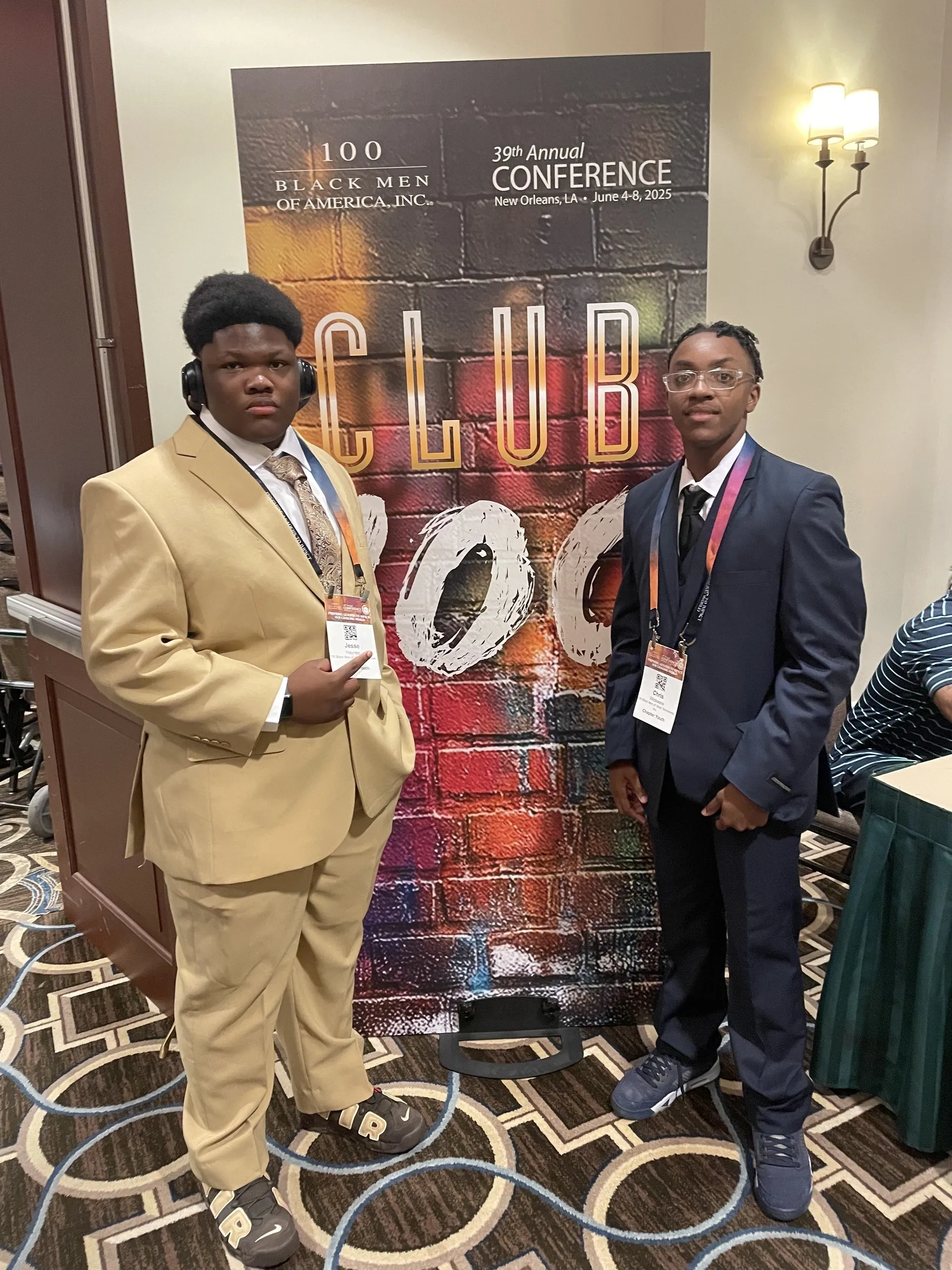 Conference attendees standing by a colorful banner