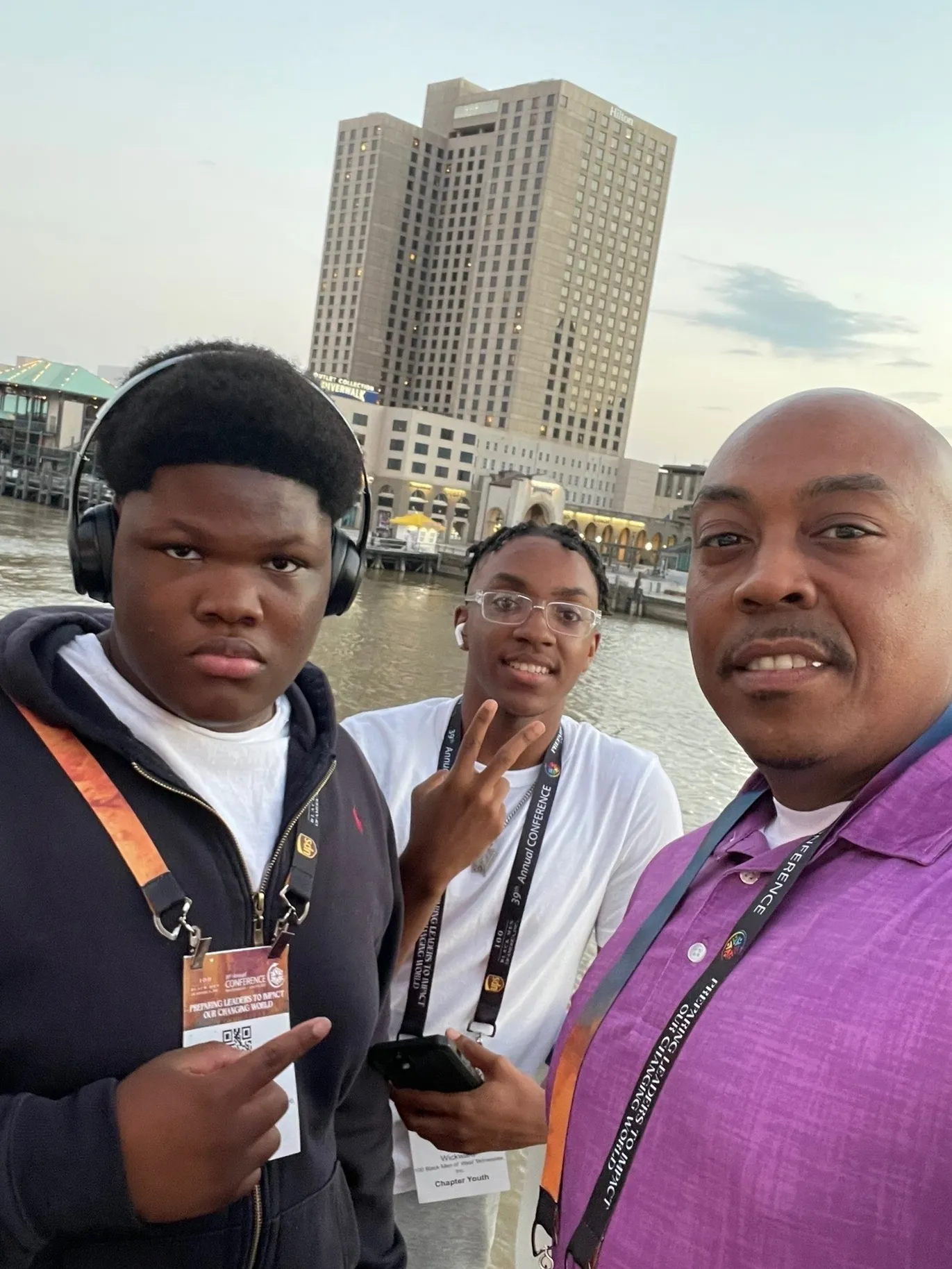 Group selfie with cityscape background